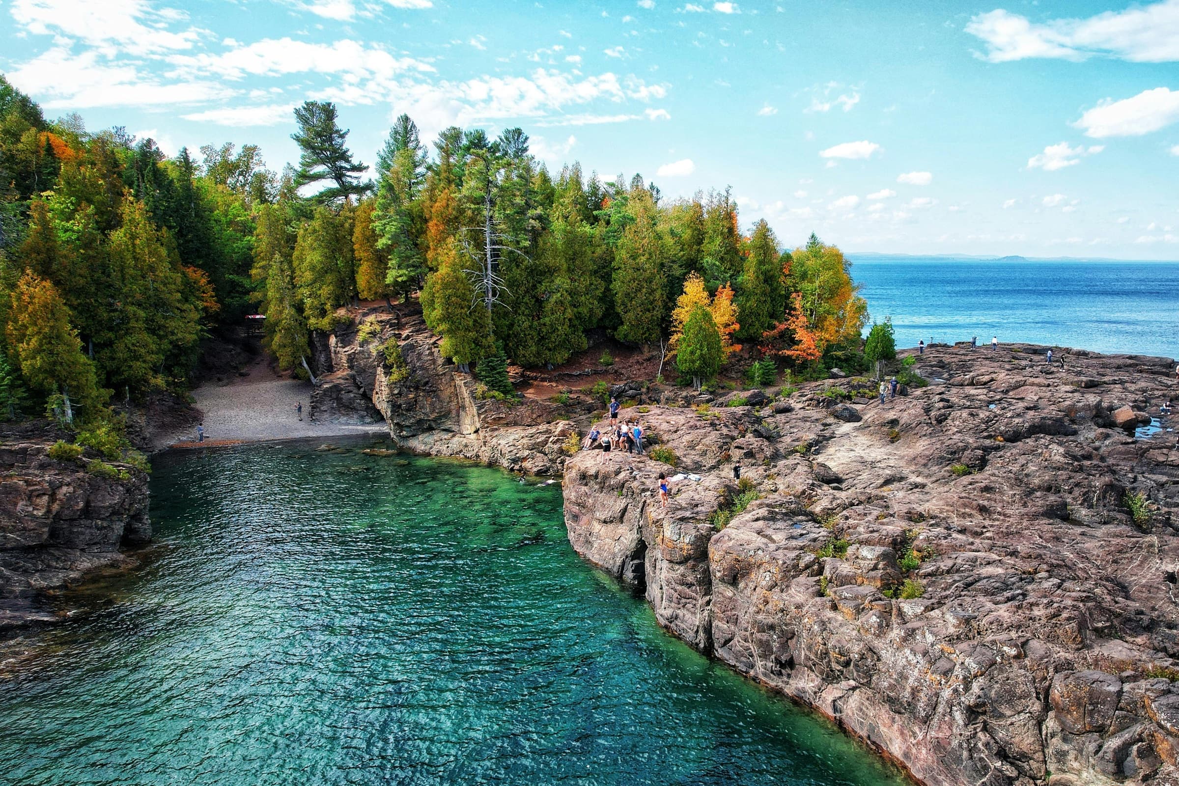 People exploring a rocky Great Lakes shoreline together